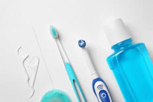 Toothbrushes And Oral Hygiene Products On White Background
