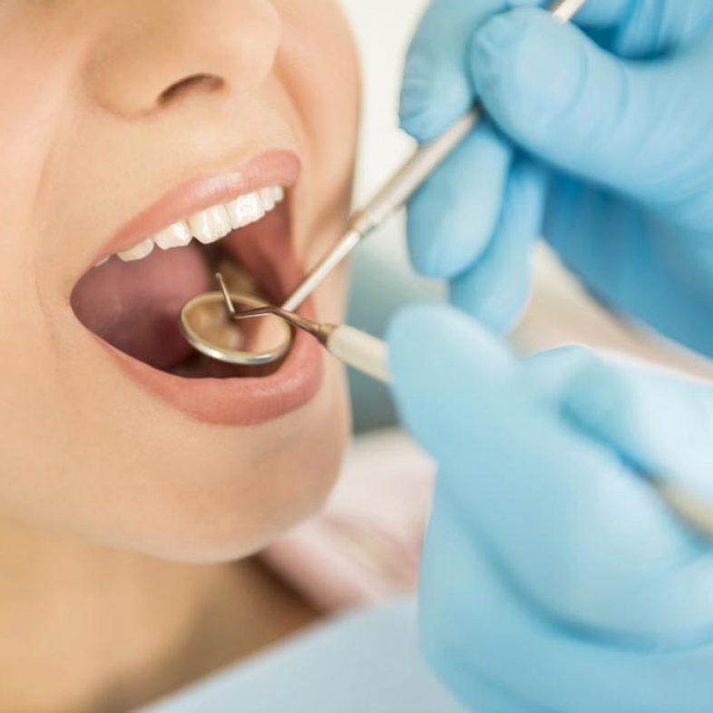 Dentist Examining Teeth